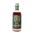 Bottle of Boatyard Old Tom Gin with label visible, showcasing rich amber color and classic design on a wooden surface.