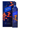 Johnnie Walker Blue Label Elusive Umami whisky bottle with elegant packaging and a dark, textured background.