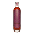 Bottle of The Orientalist Imperial Solera 23 Years Rum, a rich non-agency rum with a dark amber color, displayed on a wooden surface.