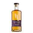 Two Stacks Double Barrel Single Pot Whiskey in a glass with a whiskey still in the background, showcasing the non-agency whiskey branding.