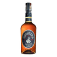 Michter's U.S. Number 1 American Whiskey bottle with label and glass, showcasing clear amber-colored whiskey in a retail setting.