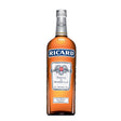 Clear glass bottle of Ricard Liqueur with yellow label and golden liquid inside on a plain background.